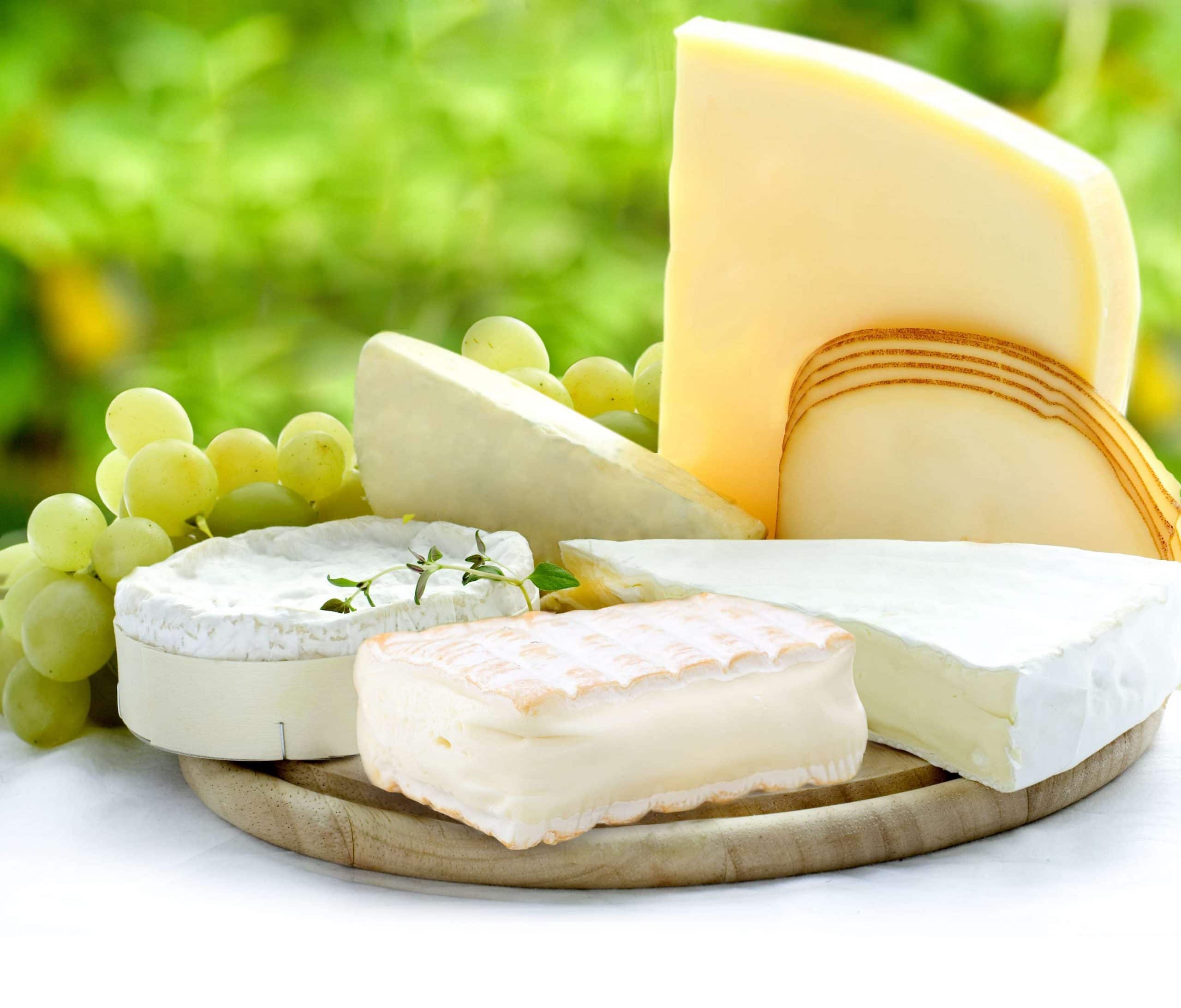 Cheese plate with a bunch of grapes